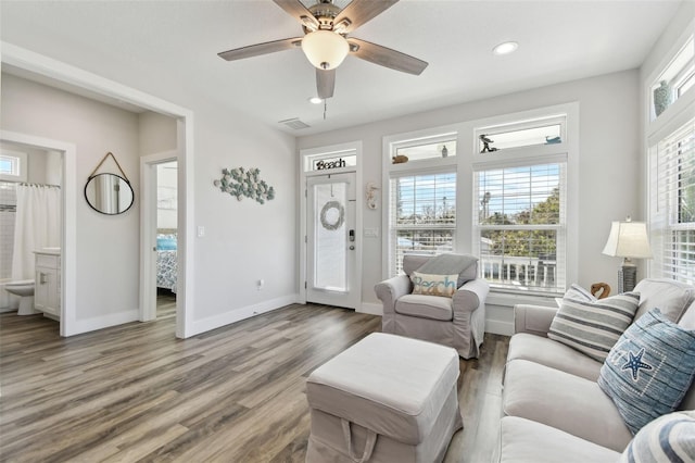 living room with wood-type flooring and ceiling fan