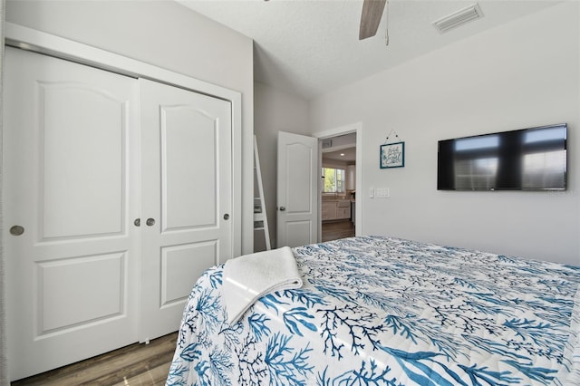 bedroom featuring ceiling fan, wood-type flooring, and a closet