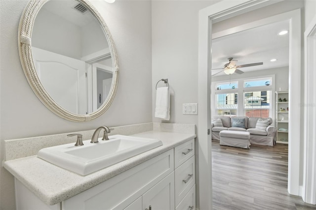 bathroom with ceiling fan, vanity, and hardwood / wood-style floors