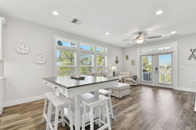 dining space with french doors, ceiling fan, and dark hardwood / wood-style flooring