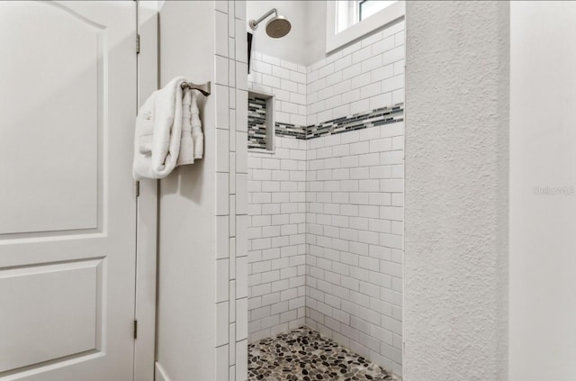 bathroom featuring tiled shower