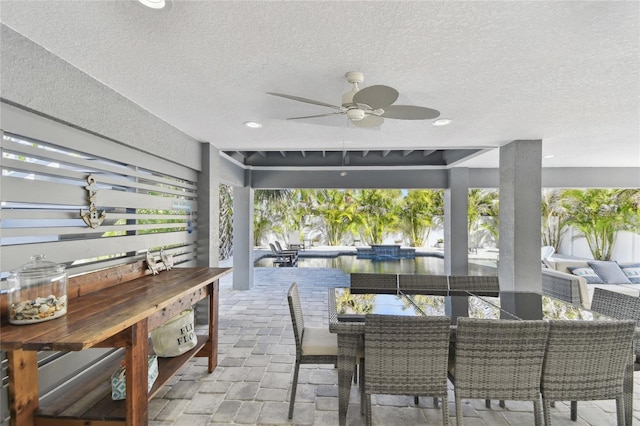 view of patio / terrace with a water view and ceiling fan