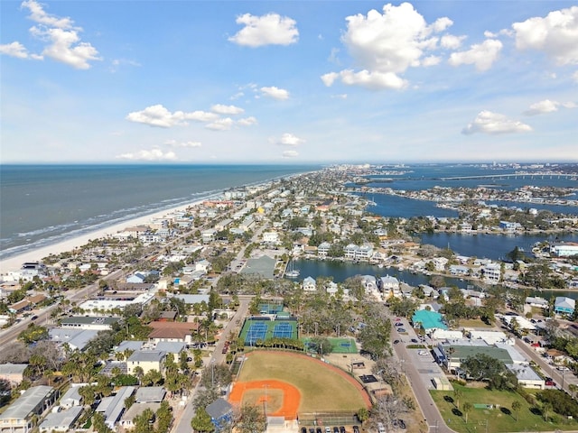 birds eye view of property with a water view and a beach view