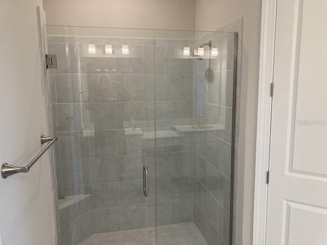 bathroom with a shower with door