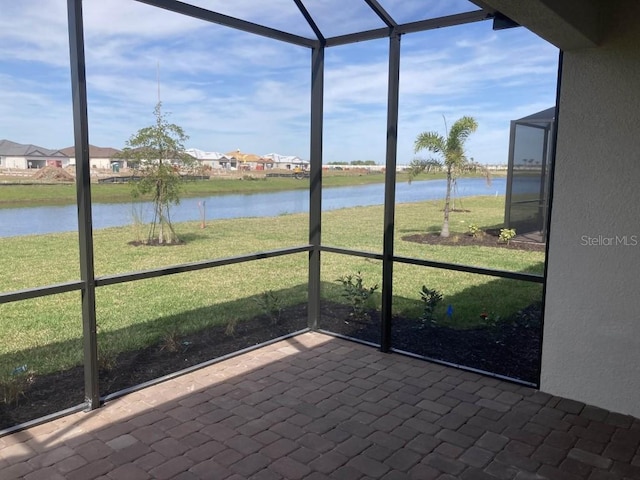 unfurnished sunroom with a water view