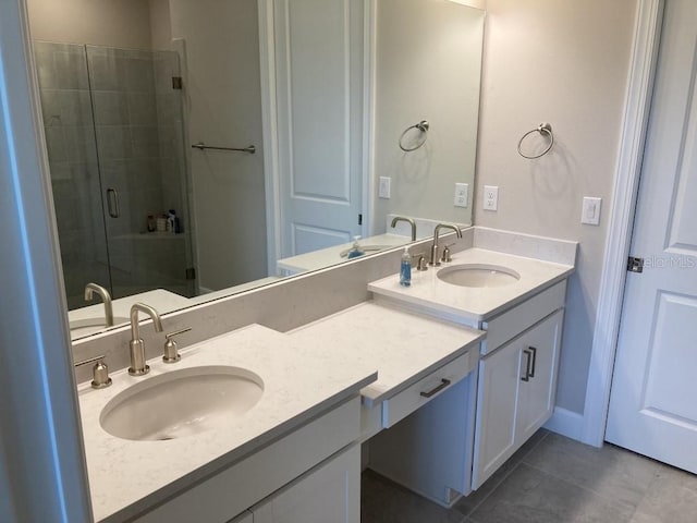 bathroom with an enclosed shower, vanity, and tile patterned floors