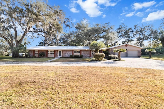 ranch-style home with a garage and a front lawn