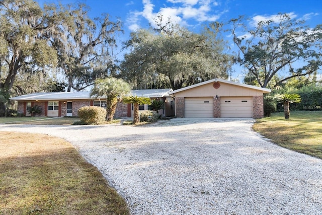 single story home with a garage and a front lawn