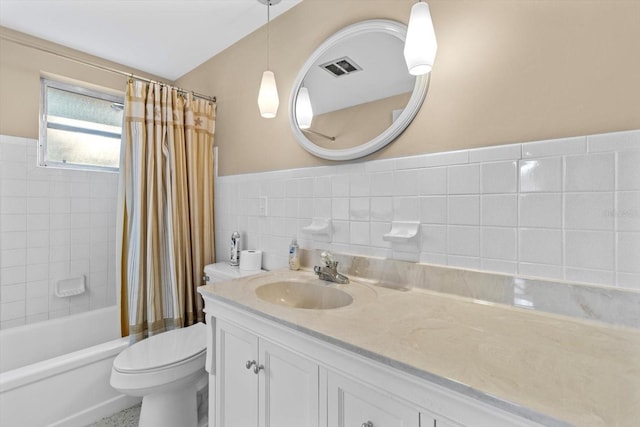 full bathroom featuring vanity, toilet, tile walls, and shower / bathtub combination with curtain