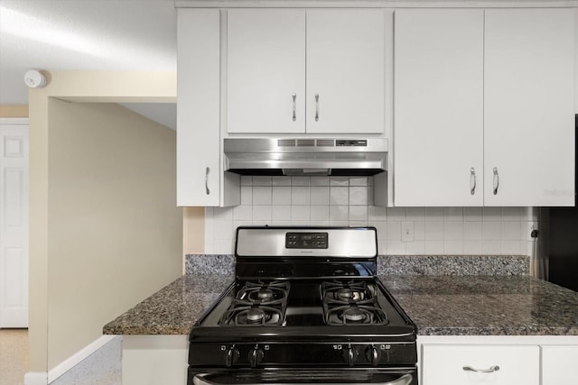 kitchen with gas range oven, backsplash, white cabinets, and dark stone countertops