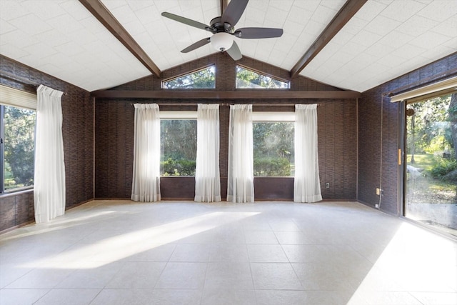 unfurnished room with ceiling fan and lofted ceiling with beams