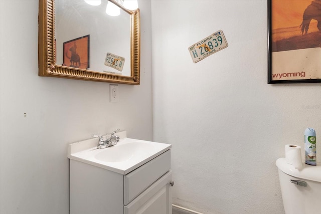 bathroom with toilet and vanity