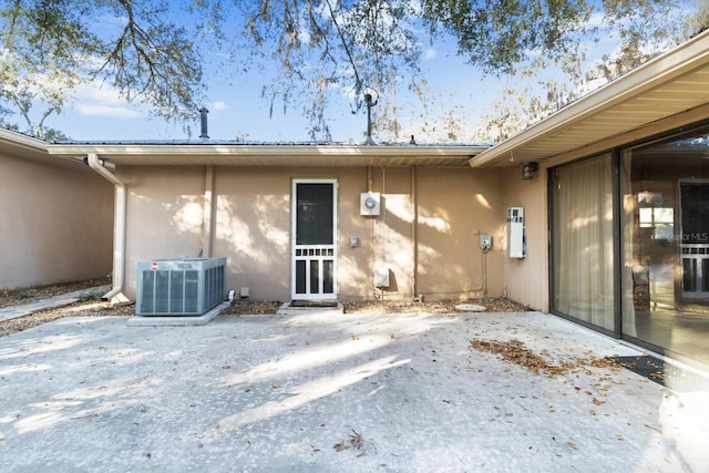 rear view of house featuring a patio and central AC unit