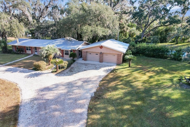 ranch-style house featuring a garage and a front yard