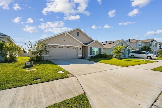 view of front of property with concrete driveway, a residential view, an attached garage, a front yard, and stucco siding