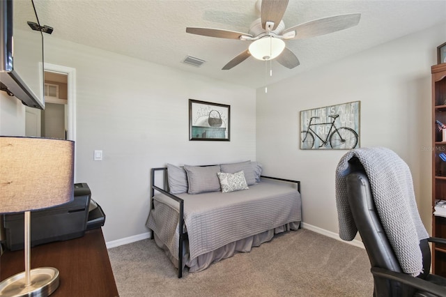 bedroom with a textured ceiling, carpet, and visible vents