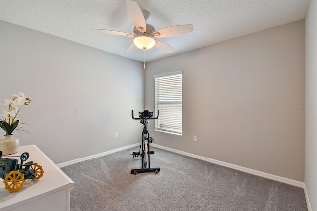 workout room featuring a textured ceiling, carpet floors, ceiling fan, and baseboards