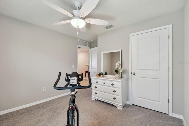 workout area featuring light colored carpet, visible vents, and baseboards