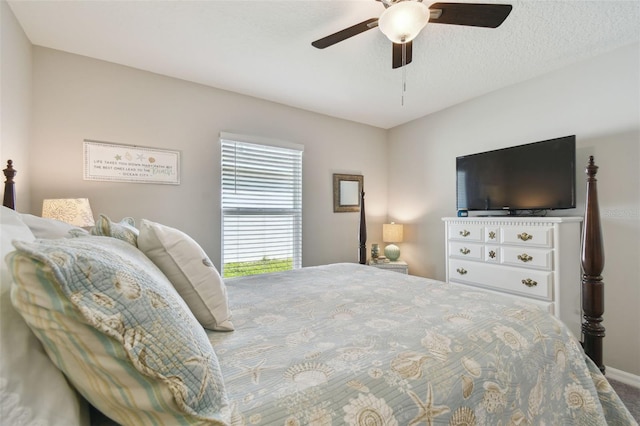 bedroom with a textured ceiling and a ceiling fan