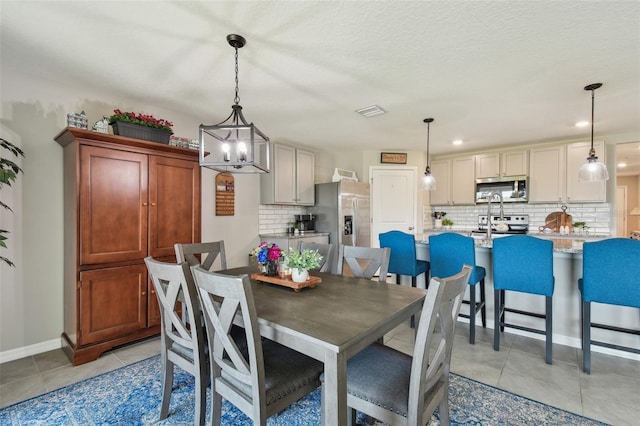 dining room with visible vents, baseboards, and light tile patterned floors