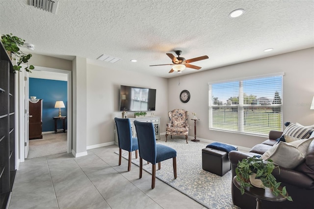 living area with ceiling fan, recessed lighting, visible vents, and baseboards