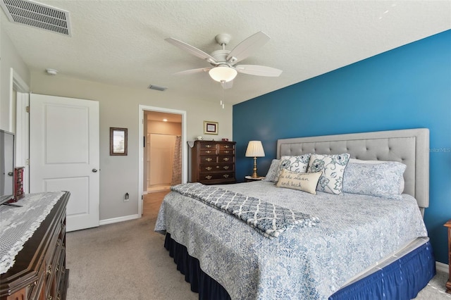 bedroom featuring baseboards, visible vents, a textured ceiling, and carpet flooring