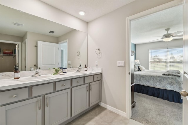 ensuite bathroom featuring double vanity, visible vents, a sink, and ensuite bathroom