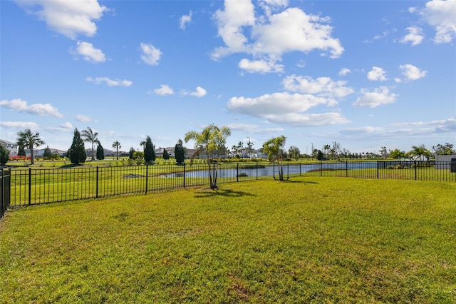 view of yard with a water view and fence