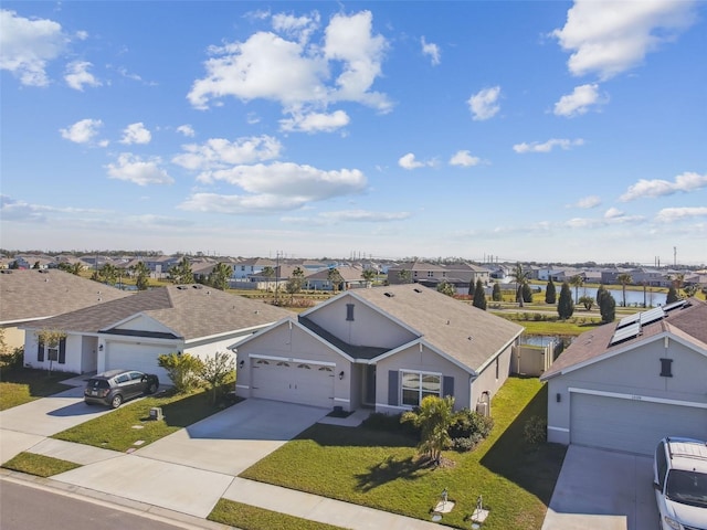 birds eye view of property with a water view and a residential view