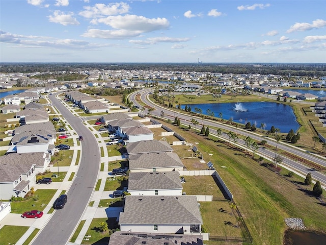 drone / aerial view with a water view and a residential view