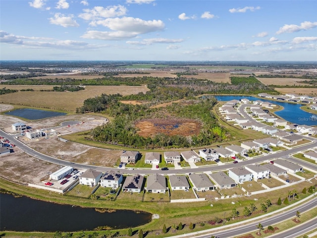 birds eye view of property with a water view and a residential view