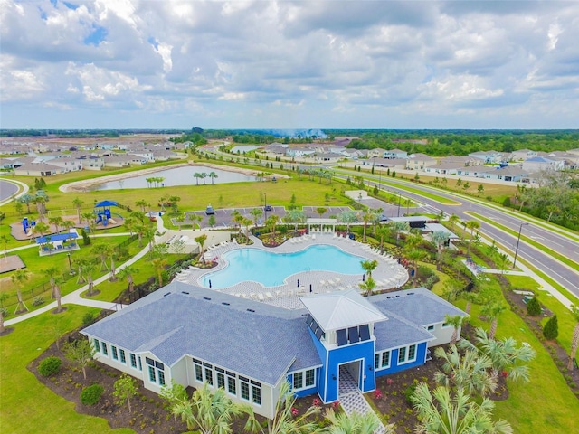 birds eye view of property with a water view and a residential view