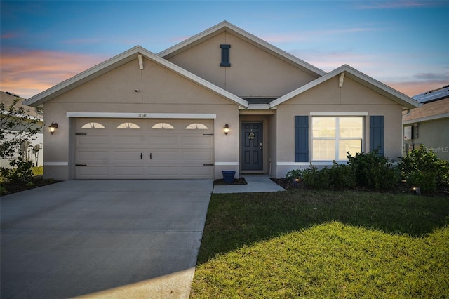 12143 Kingsley Trl, Parrish, FL 34219 - view of front of property with concrete driveway, stucco siding, an attached garage, and a front yard