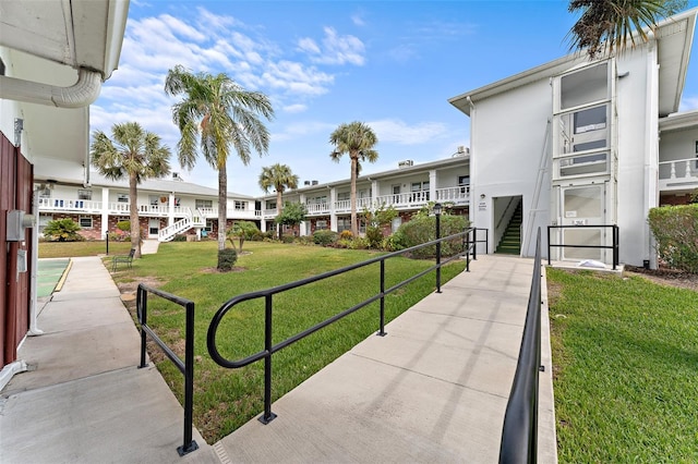 surrounding community with a yard and stairs