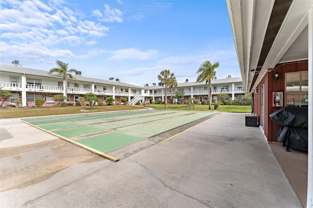 view of property's community featuring shuffleboard