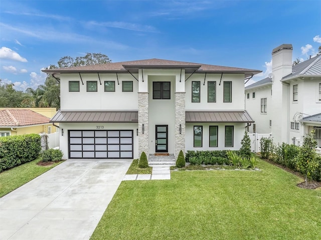 view of front of property featuring a garage and a front lawn