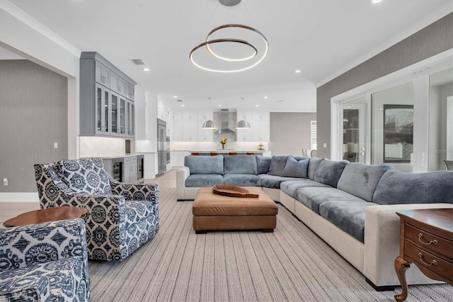 living room featuring wine cooler and crown molding