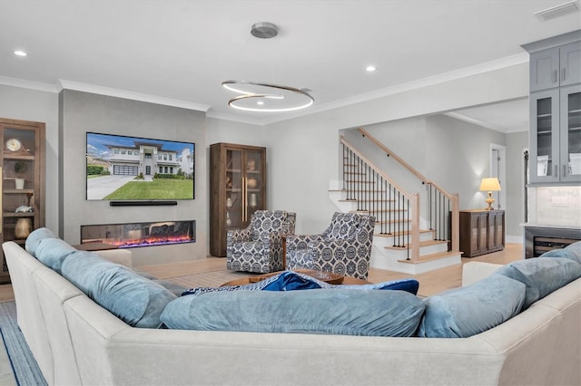 living room featuring ornamental molding and light wood-type flooring