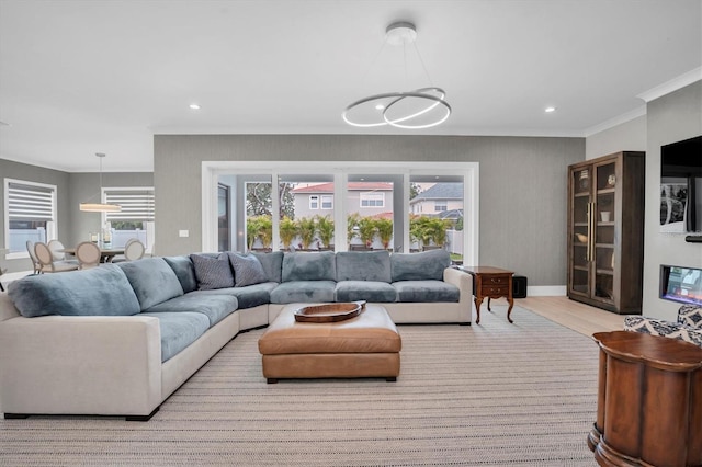 living room with ornamental molding and light hardwood / wood-style floors