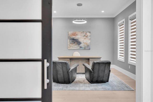 sitting room with wood-type flooring and a healthy amount of sunlight