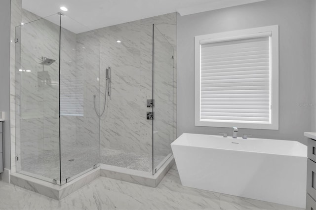 bathroom with vanity and separate shower and tub