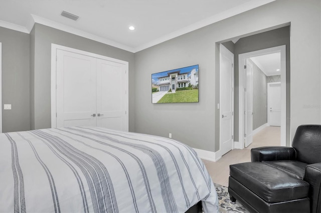 bedroom with ornamental molding, a closet, and light wood-type flooring