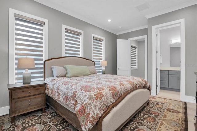 bedroom featuring connected bathroom and crown molding