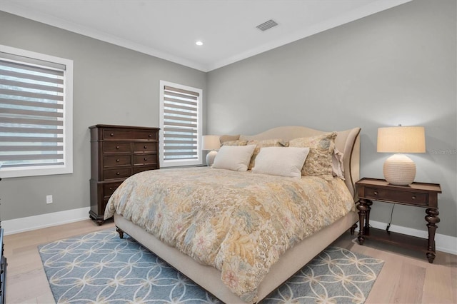 bedroom featuring ornamental molding and hardwood / wood-style floors