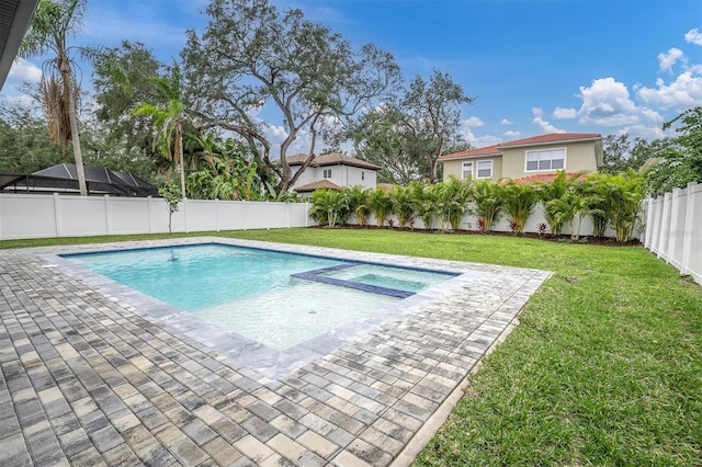 view of swimming pool featuring a lawn, a patio, and an in ground hot tub