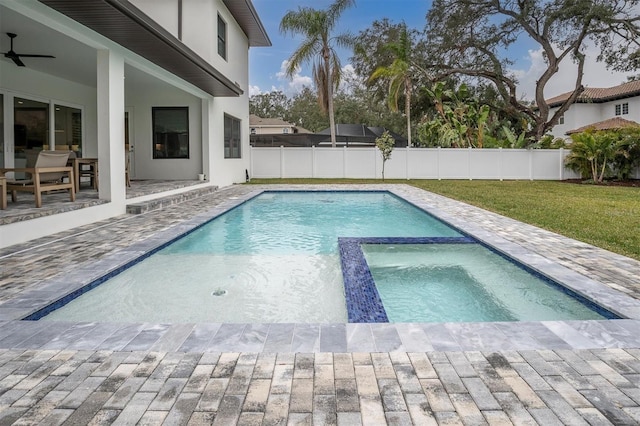 view of pool featuring a patio, ceiling fan, an in ground hot tub, and a lawn