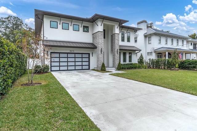 view of front of house with a garage and a front yard