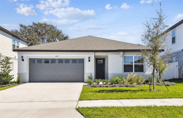 view of front of property featuring a front lawn and a garage