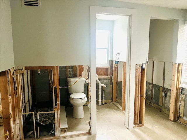 bathroom with toilet and tile patterned floors