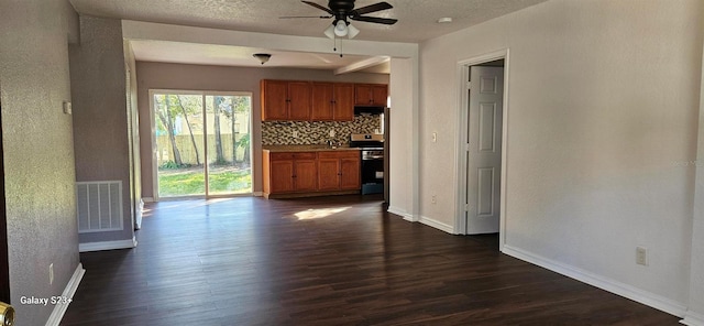 interior space with dark hardwood / wood-style floors, stainless steel stove, tasteful backsplash, ceiling fan, and a textured ceiling